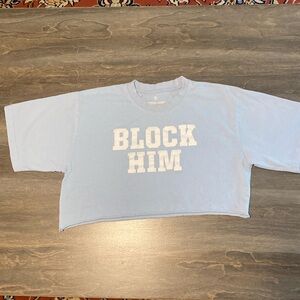 Juniors cropped T-shirt. Lt blue, white letters say “BLOCK HIM” Size M